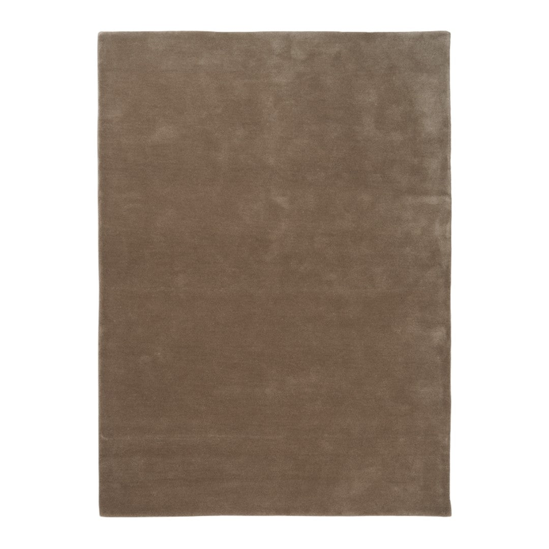 Brown solid color area rug with a soft texture, perfect for adding warmth to any space.
