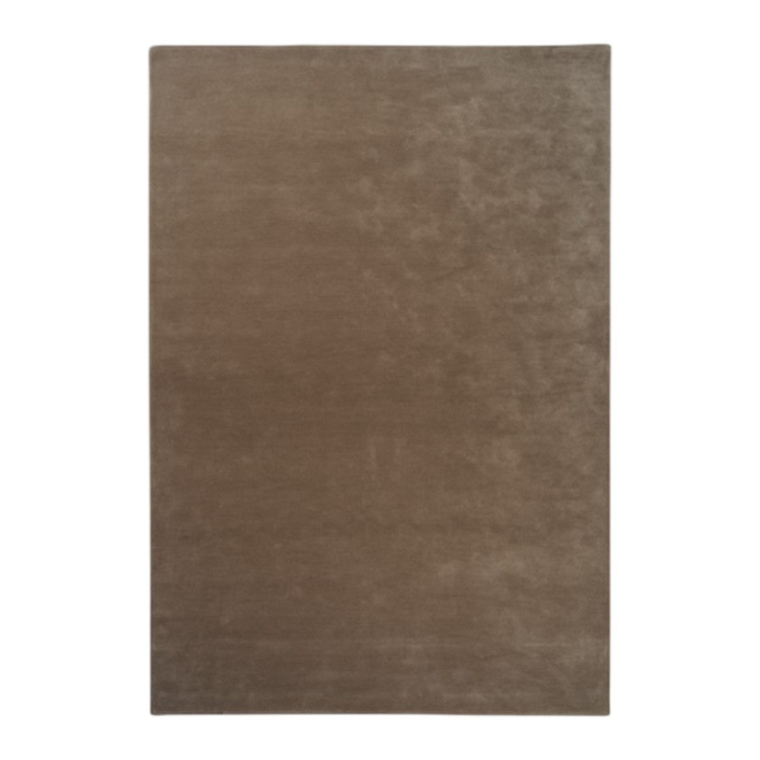 Solid taupe area rug with a plush texture, featuring a smooth, even surface and warm earthy tones.