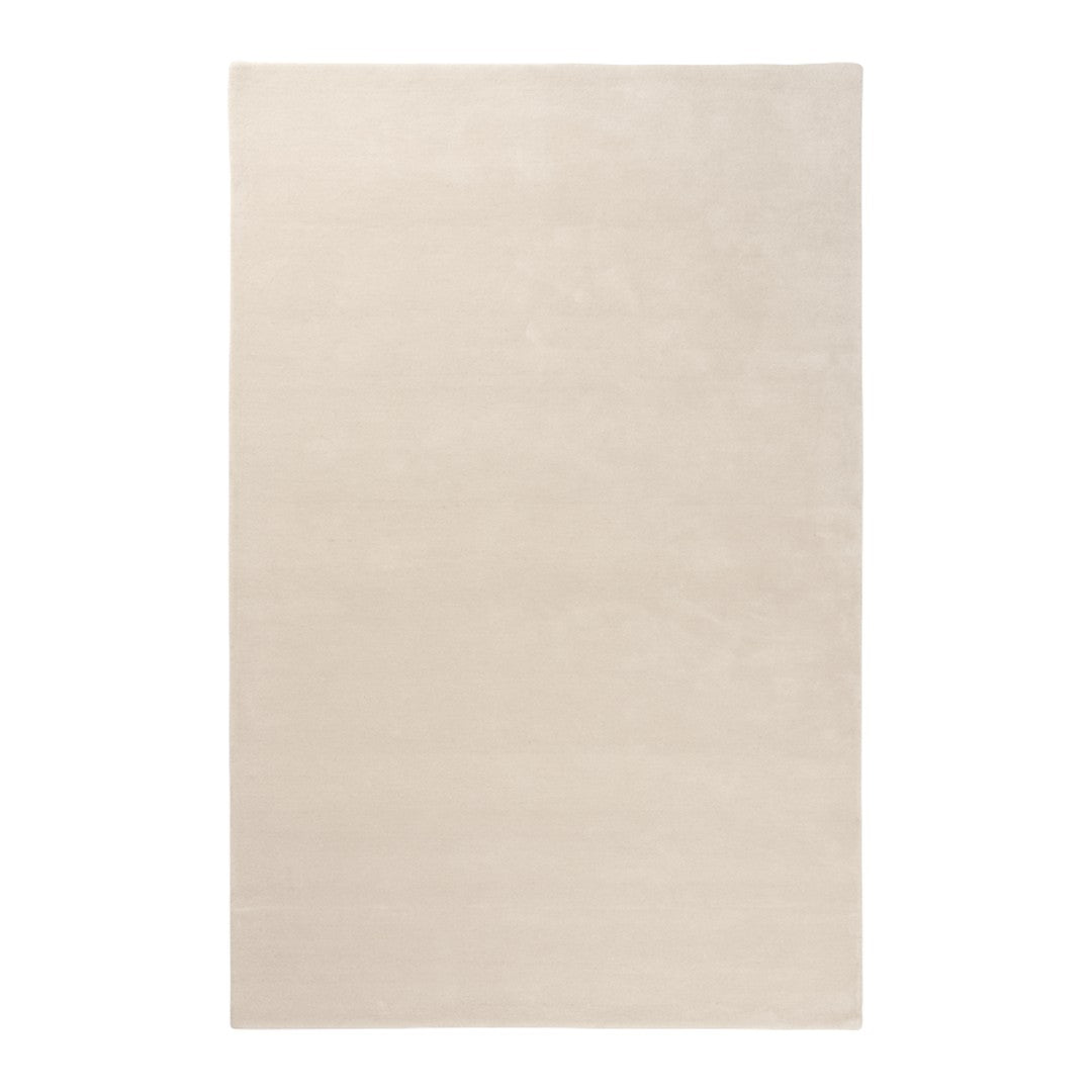 Soft beige area rug with a smooth, solid pattern, adding a warm touch to any room decor. Perfect for minimalist designs.