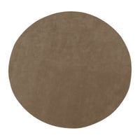 Round suede rug in a warm taupe color with a smooth, solid pattern. Ideal for modern home decor.