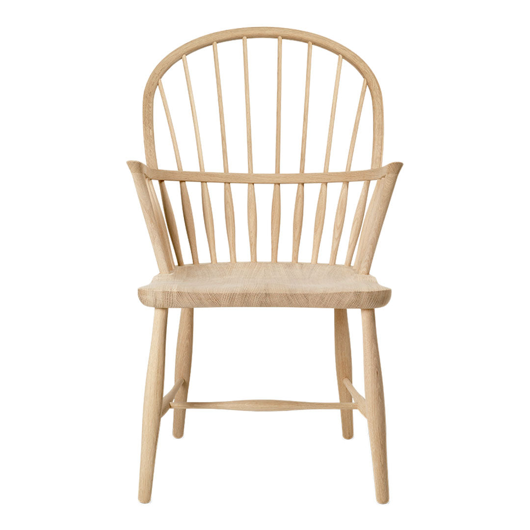 Natural wood chair with a light beige finish and simple, clean lines. Classic spindle back design for a minimalist look.