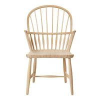 Natural wood chair with a light beige finish and simple, clean lines. Classic spindle back design for a minimalist look.