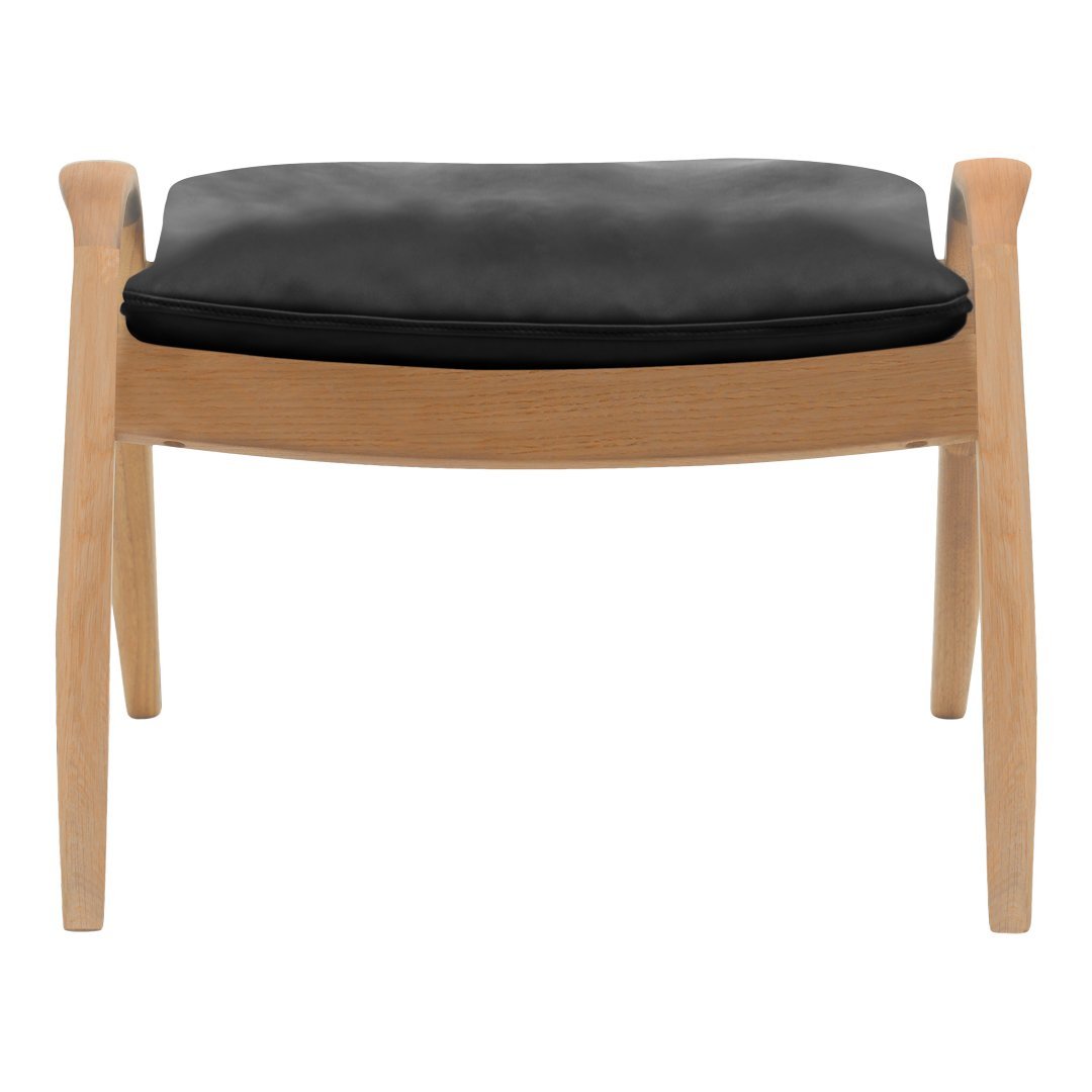 Black cushioned ottoman with natural wood legs, featuring a sleek and minimalist design. Perfect for modern interiors.