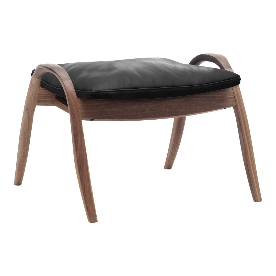 Black leather cushion with a smooth texture on a warm, natural wood frame showcasing curved, elegant legs.