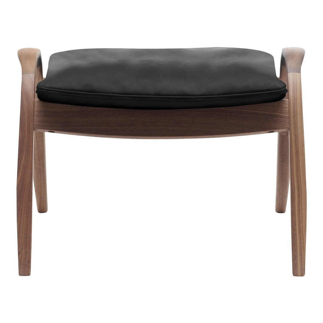 Stylish wood stool with a smooth walnut finish and a sleek black cushion. Modern design with minimalistic elegance.