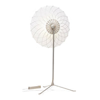 White circular shade with intricate, layered geometric pattern and silver metal stand. Modern, elegant design for decor.