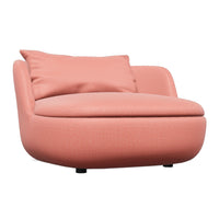Round, peach-colored chair with smooth, textured fabric and a plush pillow for added comfort. Perfect for modern decor.