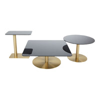 Gold metal bases support sleek black glass tops in dynamic shapes, perfect for modern home decor.