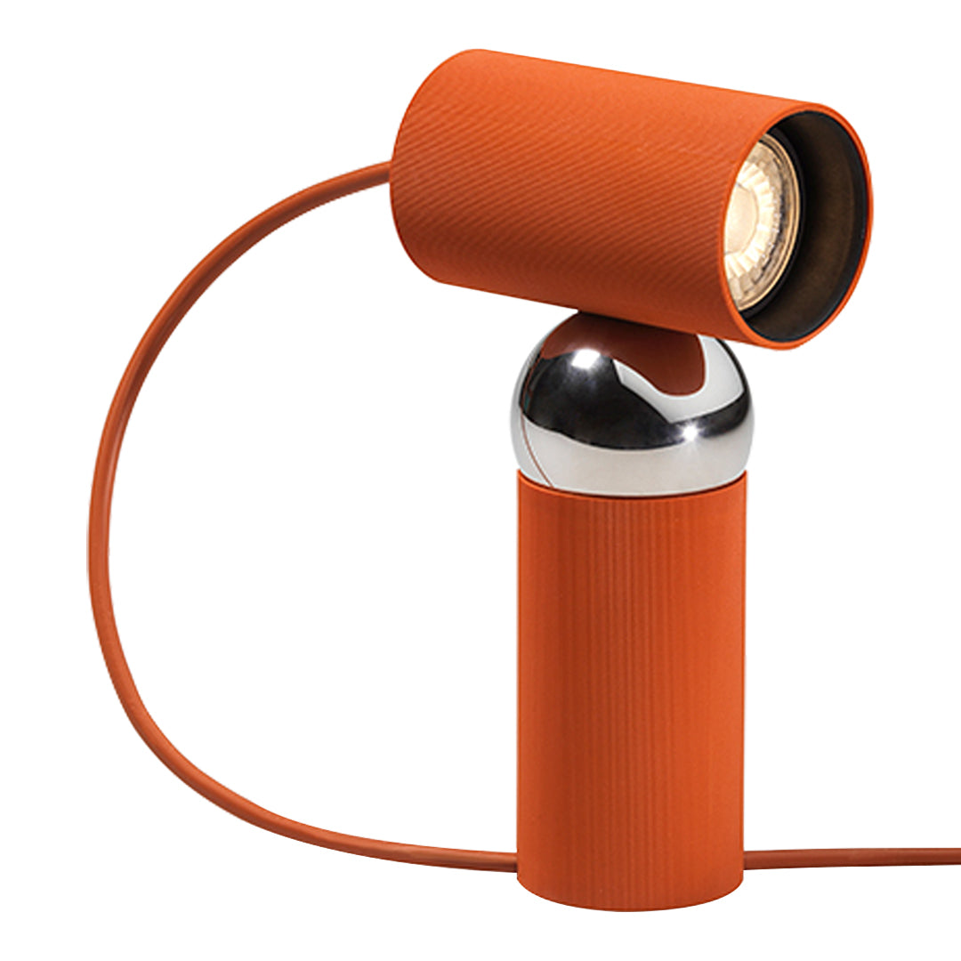 "Contemporary orange lamp with textured finish and metallic accents, featuring a sleek, modern design."