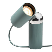 Modern teal lamp with ribbed texture and polished chrome accents, featuring a sleek, minimalist design.