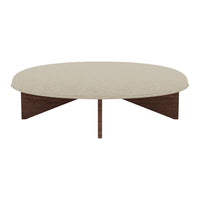 Beige round coffee table with a textured surface and dark brown wooden legs, combining modern style and earthy tones.