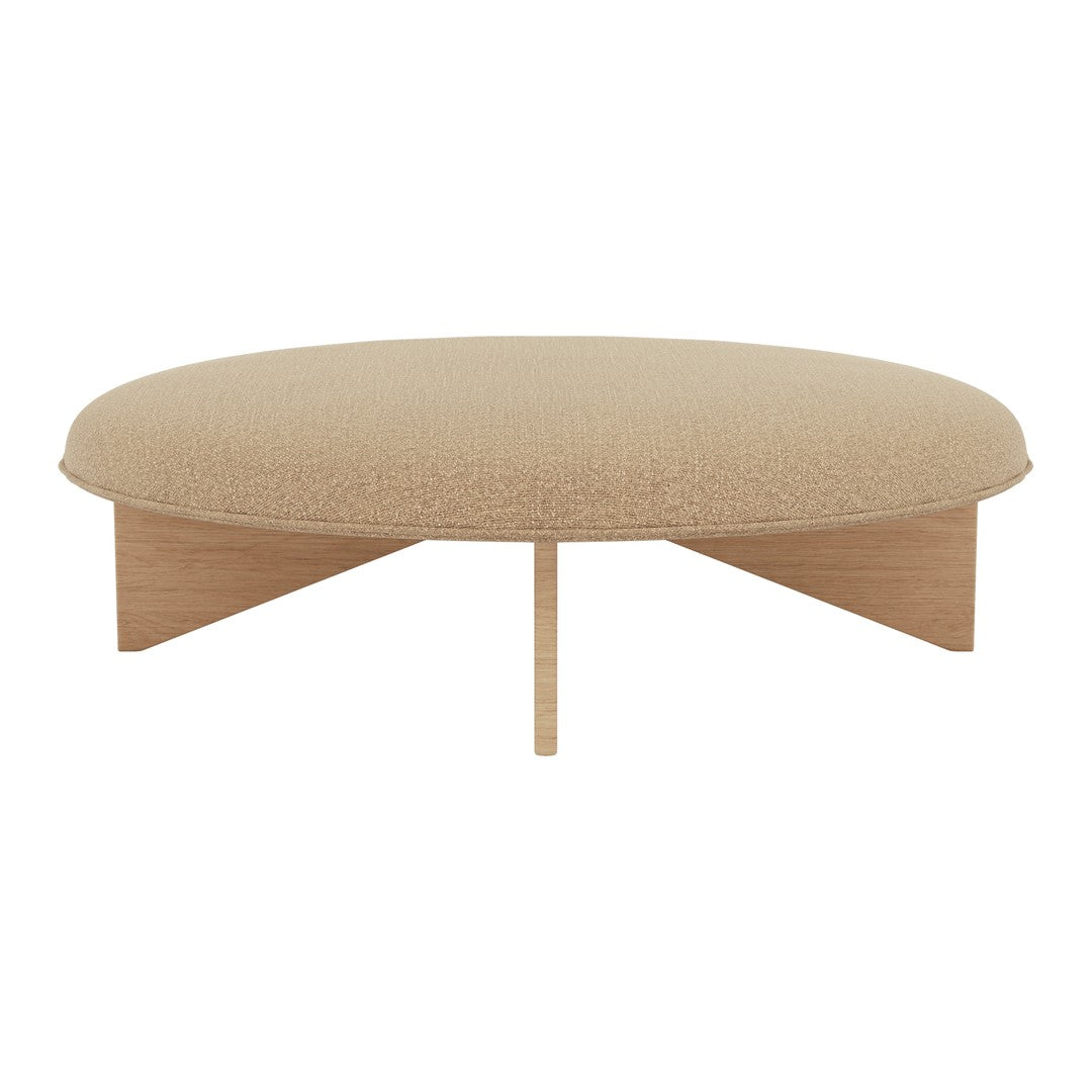 Beige round coffee table with textured fabric and natural wood legs, offering a minimalist, modern aesthetic.