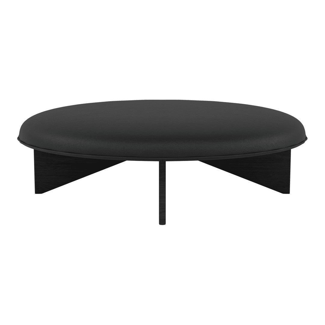 Round black coffee table with a smooth surface and minimalist design, featuring geometric black legs.