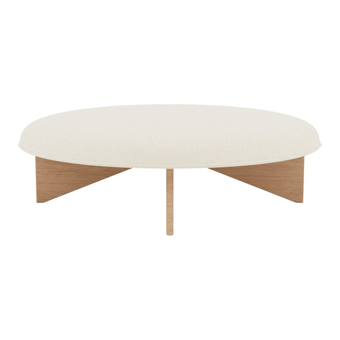 Round coffee table in soft white with natural wood legs and a minimalist design, enhancing contemporary interiors.