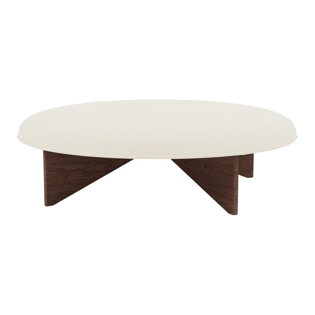 Round white coffee table with smooth matte finish and dark wood angled legs. Modern minimalist design.