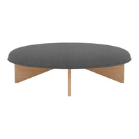 Round coffee table with a dark gray fabric top and natural wood base, featuring a sleek, modern design.