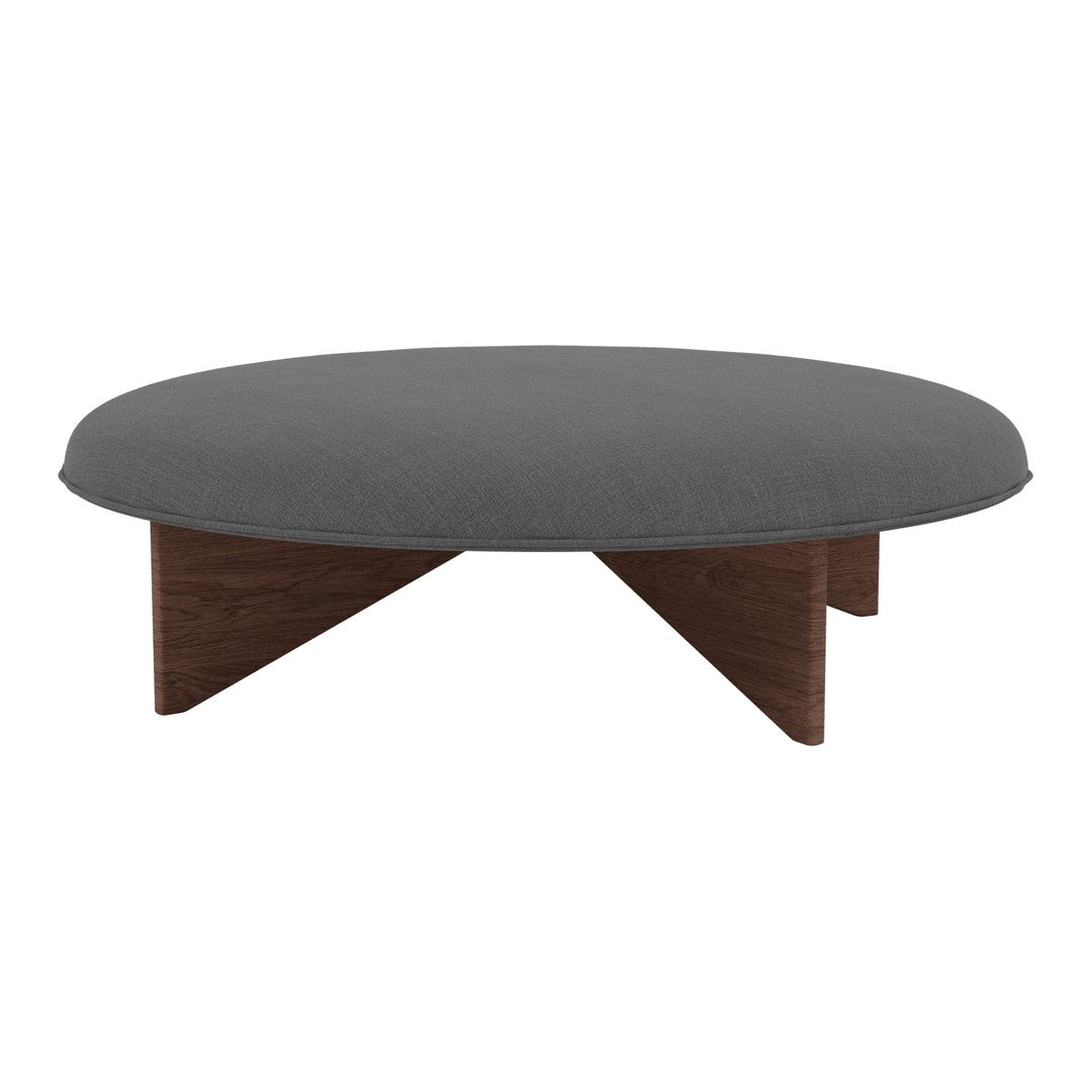 Round coffee table with a gray fabric top and natural wood legs, featuring a minimalist design and smooth surfaces.