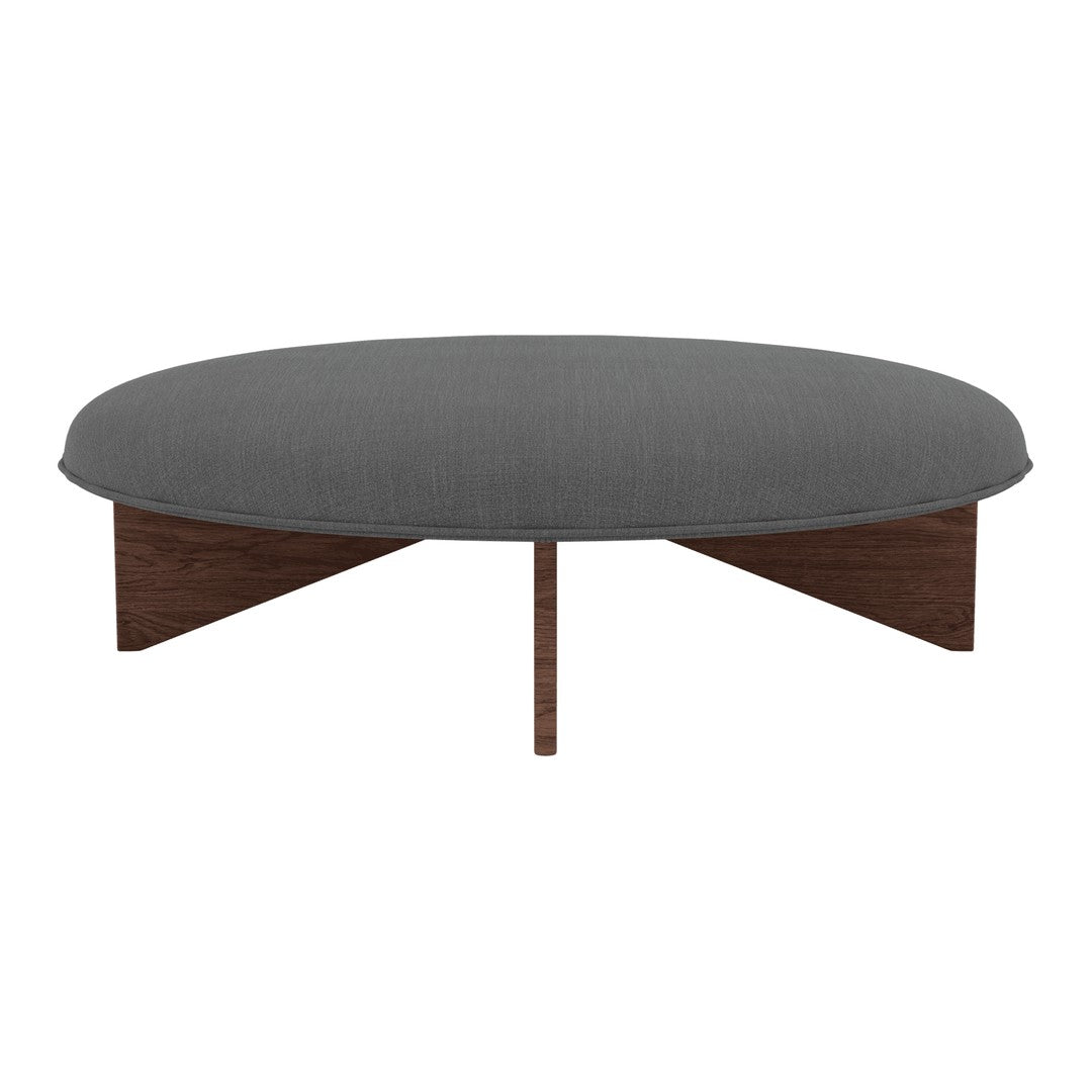 Round coffee table in dark gray fabric with smooth, textured surface and wooden base in rich brown finish.