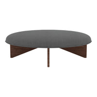 Round coffee table in dark gray fabric with smooth, textured surface and wooden base in rich brown finish.
