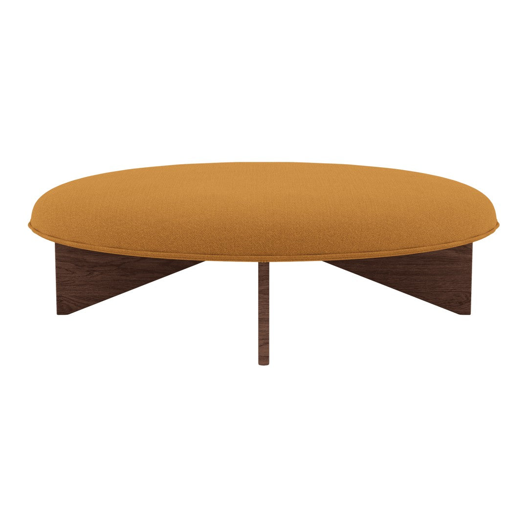 Round coffee table with a warm mustard yellow fabric top and a sleek wooden base. Modern and stylish design.