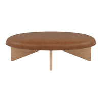 Round leather ottoman in warm brown with simple wooden legs, creating a modern and minimalistic design.