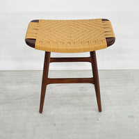 Natural woven rattan seat with a geometric pattern on a dark wood frame. Earthy tones enhance any decor style.