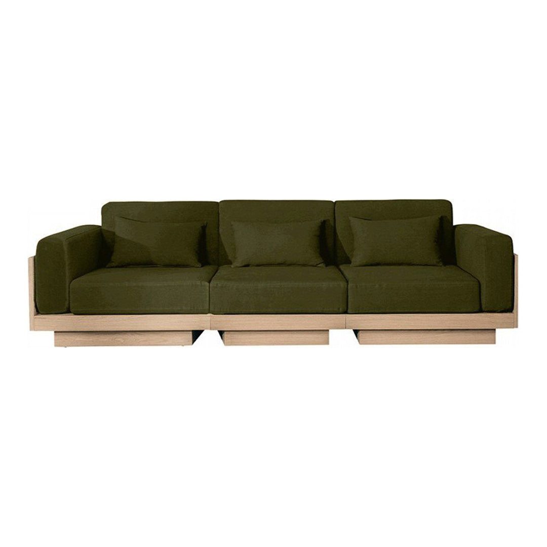Olive green fabric sofa with plush cushions and minimalist wood base, perfect for modern living spaces.