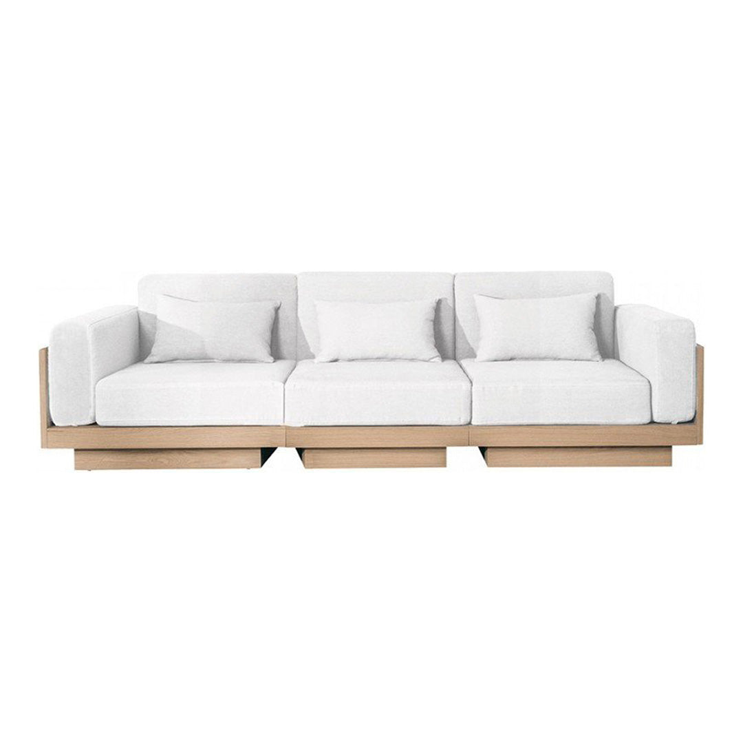 White modern sofa with plush cushions and a light wooden base, featuring a clean, minimalist design.