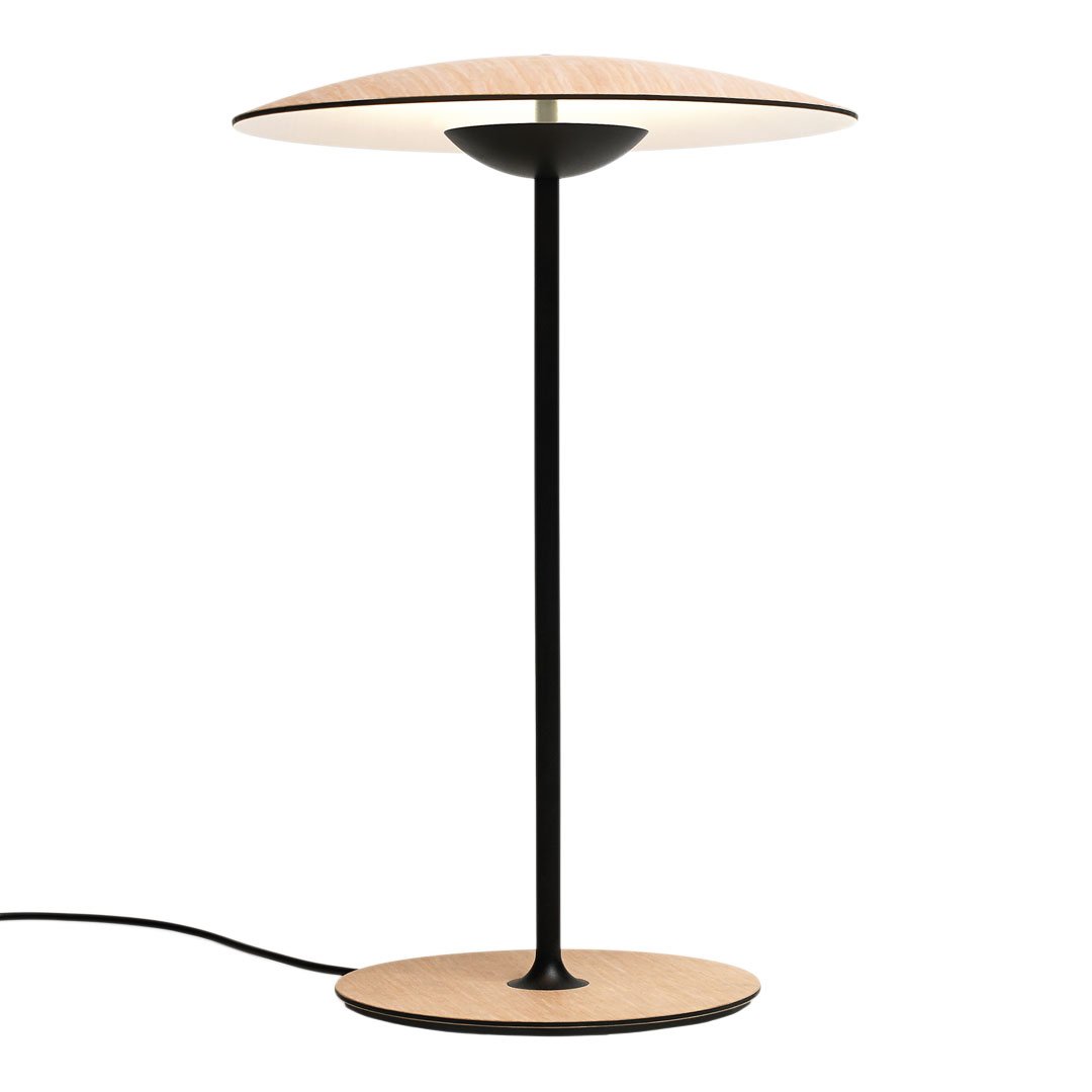 Modern lamp with a black base and stem, featuring a beige, round shade for a sleek, minimalist design.