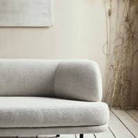 Light gray textured sofa with a curved armrest and minimalist design, perfect for modern decor.