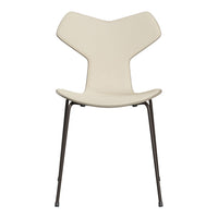 Modern cream chair with a unique butterfly shape and sleek black legs, perfect for contemporary decor.