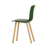 Green chair with a smooth finish and natural wood legs, showcasing a sleek, modern design.