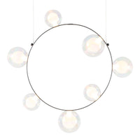 Round black metal pendant light with seven iridescent glass bulbs creating a modern, minimalist aesthetic.