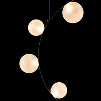 Modern black and white pendant light with four round white globes and sleek metallic arc design.