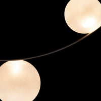 Soft white orb lights on a sleek, curved wire against a black background, creating a modern decorative pattern.