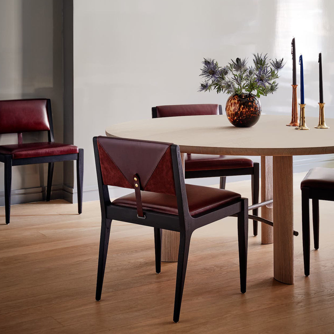 Modern dining chairs in deep burgundy and black accents, featuring sleek lines and a stylish leather finish.