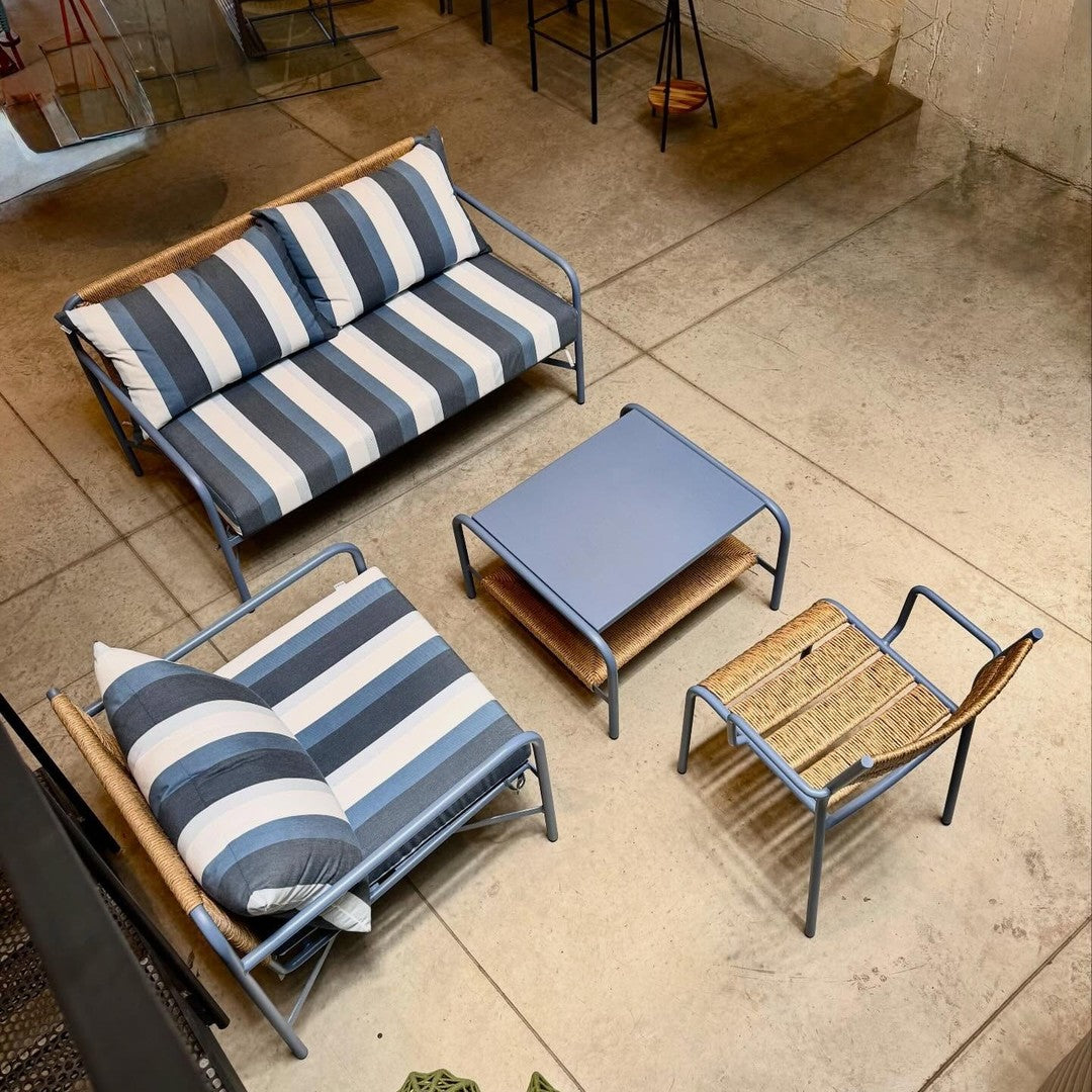 Blue and white striped outdoor furniture set with a natural wood accent. Modern design perfect for any patio space.