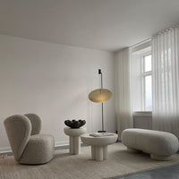Neutral tones, soft textures, and modern shapes create a cozy, minimalist living room aesthetic.
