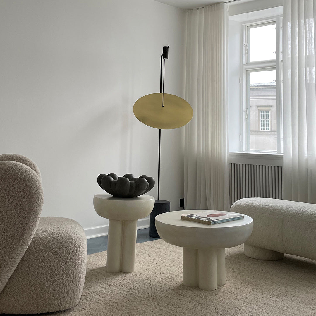 Modern living room featuring neutral tones, soft textures, and subtle geometric patterns for a cozy atmosphere.