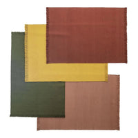 Colorful placemats in olive green, mustard yellow, warm rust, and soft peach with fringed edges. Ideal for stylish dining.