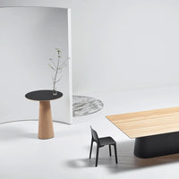 Modern black and wood furniture with minimalist patterns over a neutral backdrop featuring soft textures and clean lines.