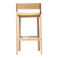 Light wood bar stool with a sleek design, featuring a vibrant yellow seat cushion for a pop of color.