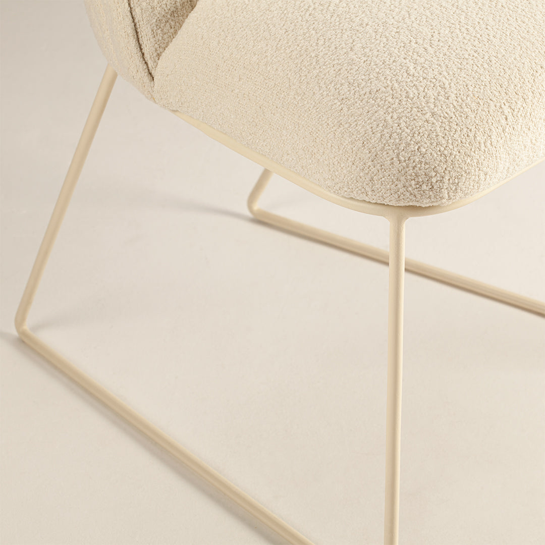 Cream textured fabric chair with light beige metal legs, ideal for a modern minimalist aesthetic.