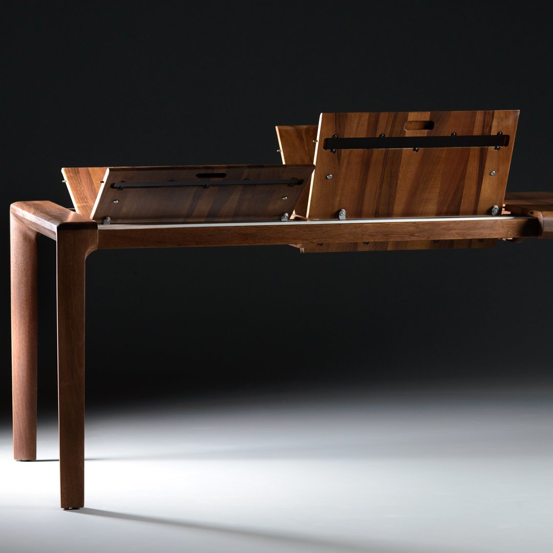 "Elegant wooden table with a rich brown finish and smooth, minimalist design featuring subtle wood grain patterns."
