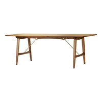 Natural wood dining table with a smooth finish and minimalistic design, featuring tapered legs and elegant lines.