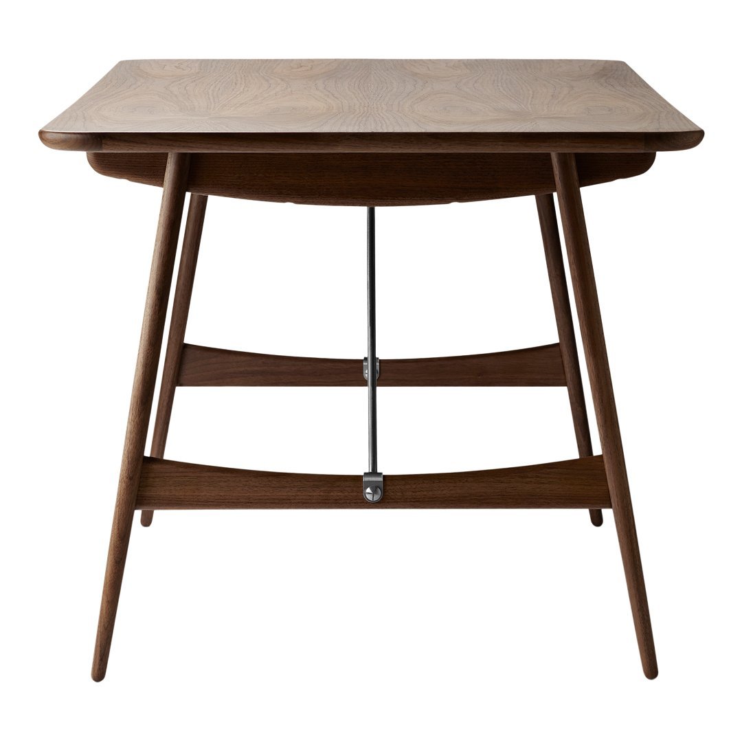 "Elegant walnut dining table with a smooth finish and stylish tapered legs."