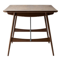 "Elegant walnut dining table with a smooth finish and stylish tapered legs."