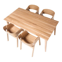 Light oak dining table with a smooth finish, paired with natural wooden chairs in a simple, minimalist design.