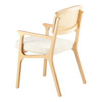 Light wood chair with white cushion and woven back, showcasing a minimalist design and neutral color palette.