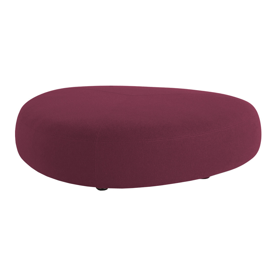 Plush oval ottoman in deep burgundy fabric, featuring a smooth, solid color design for a modern touch.